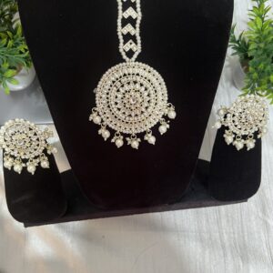 White pearl stud earrings with maang tikka